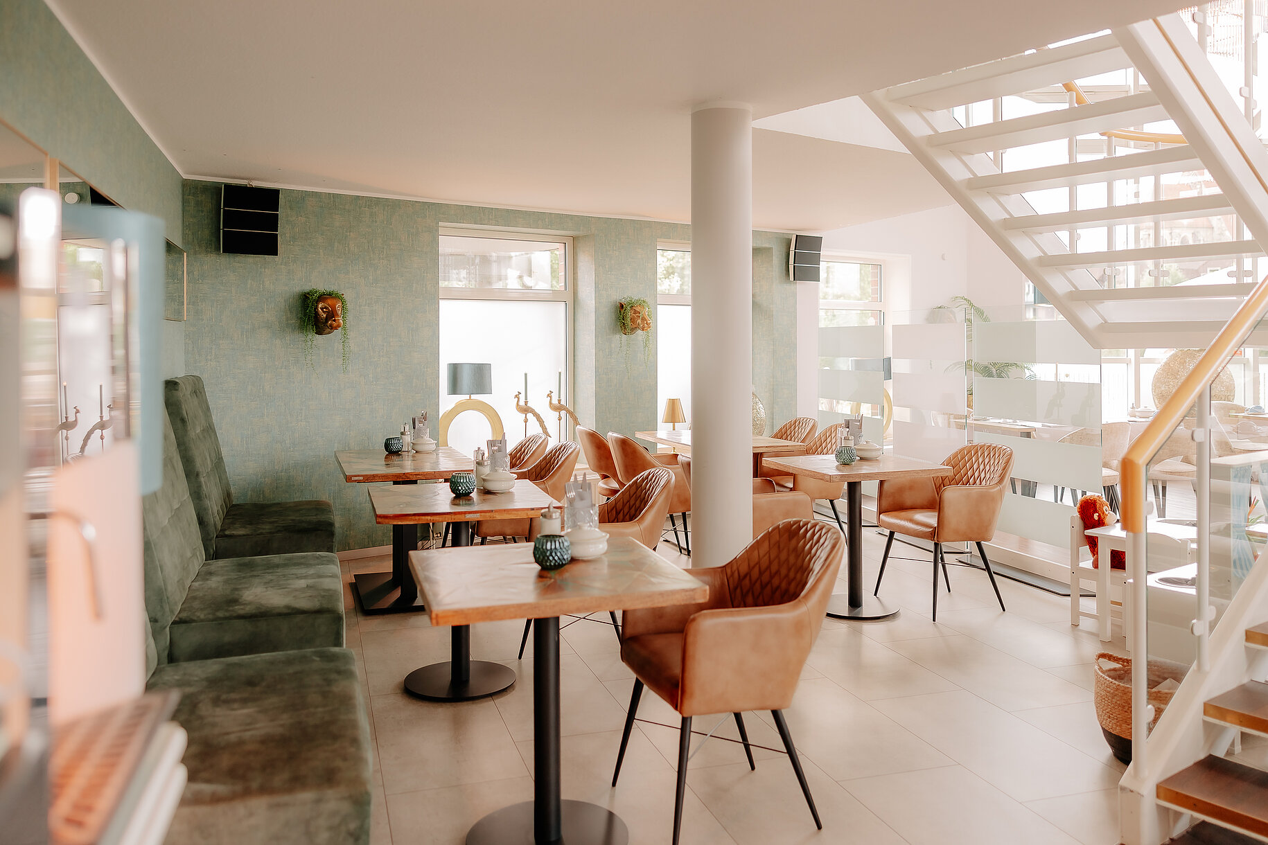 Gemütlicher Sitzbereich mit modernen Sesseln und grünem Wanddesign im CASCADA Hotel Rheine